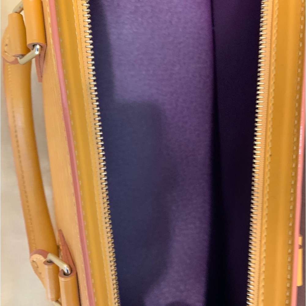 Luis Vuitton authentic yellow with purple interior rectangular.